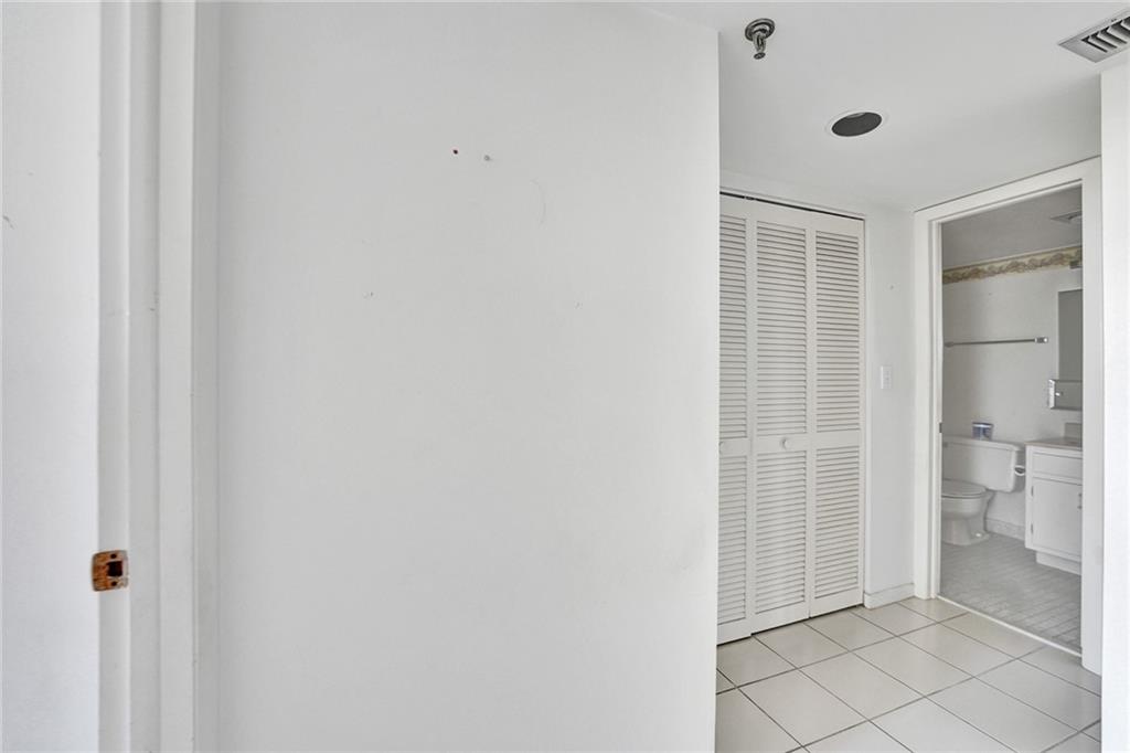 When you enter the second bedroom, the bedroom is on the left, over looking the water, and the second bathroom is to your right. A full size washer and dryer are behind the louvered doors.
