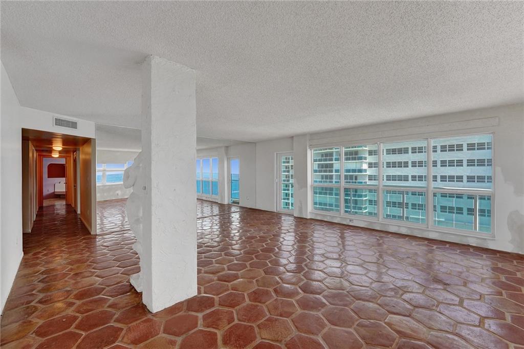  The corridor leads down to the half bath and the 3 bedrooms. The column is load bearing.