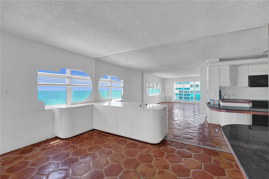  This area would be perfect for an eat in or a dining area. The kitchen is to the right.