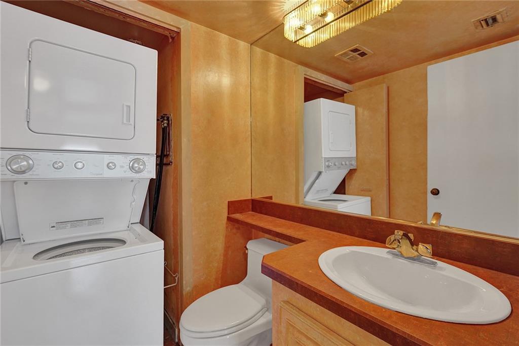 The half bathroom has room for a washing machine and a dryer.