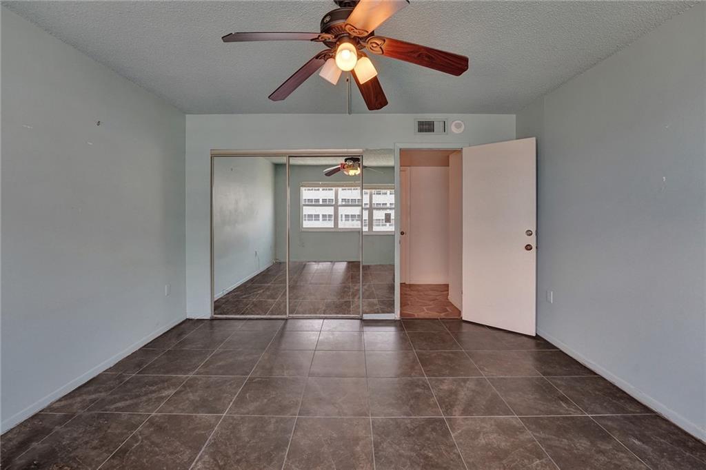 This first guest bedroom. A closet is behind the mirrored doors.