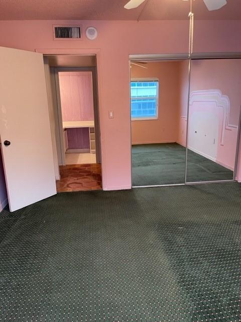 The second guest bedroom, facing into the guest bathroom. A closet is behind the mirrored doors.