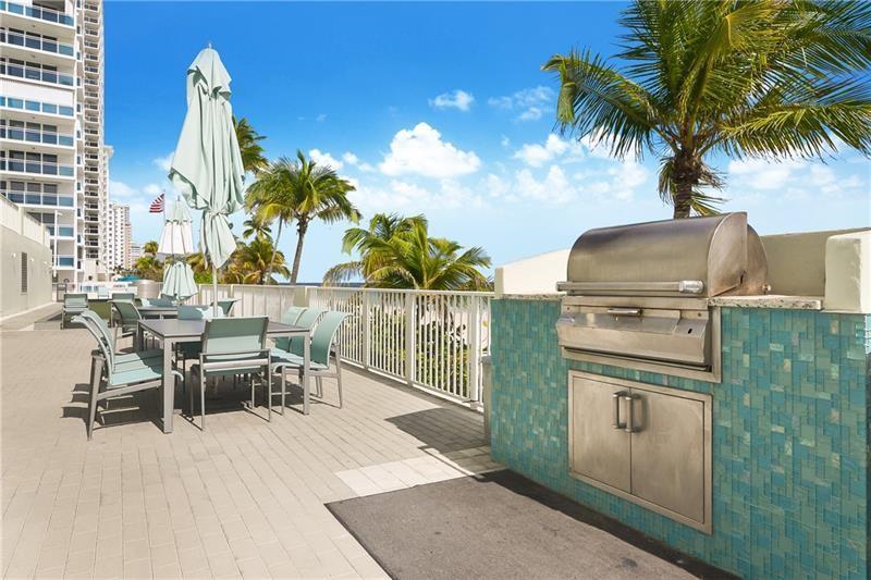 The lower beach deck is just below the upper pool deck. There are two bbq grills, a bocce court and stairs leading up to the pool and the tennis deck.