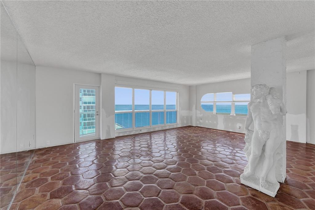 The glass door leads out to the balcony. The statue is guarding the apartment.