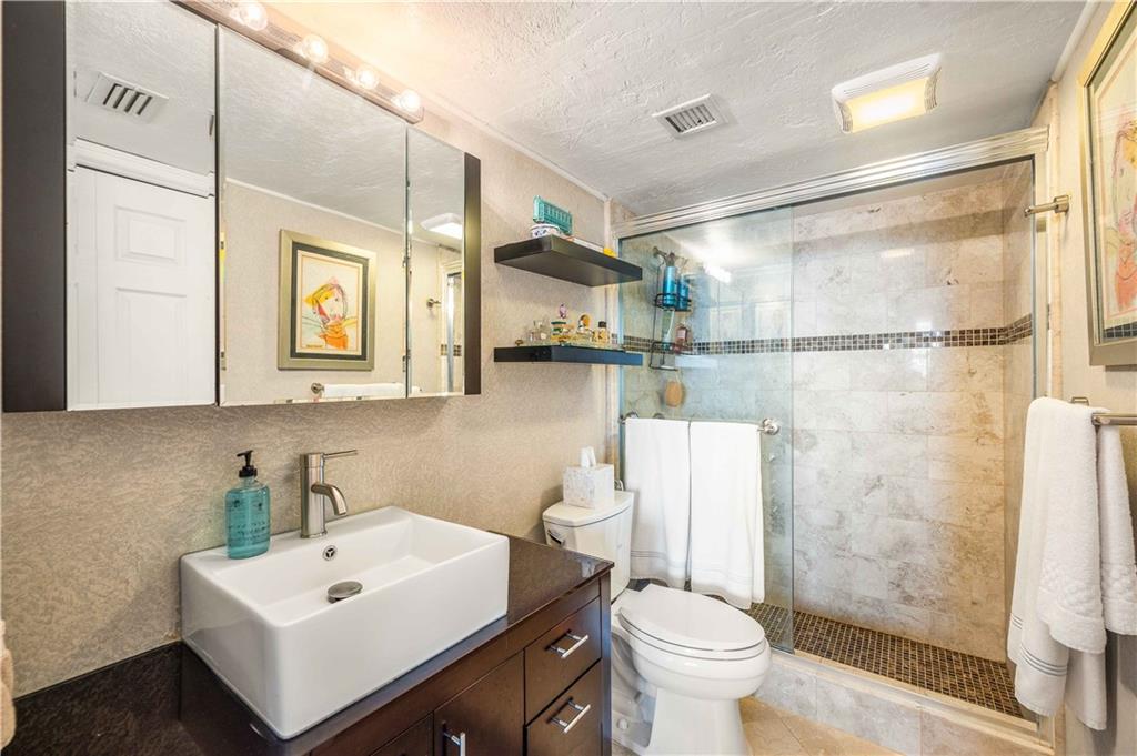 Tastefully remodeled master bathroom with linen closet.