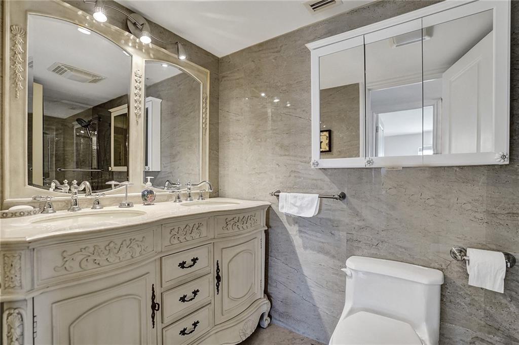 The second bathroom has a granite topped vanity and double sinks. It is right across from the second bedroom.