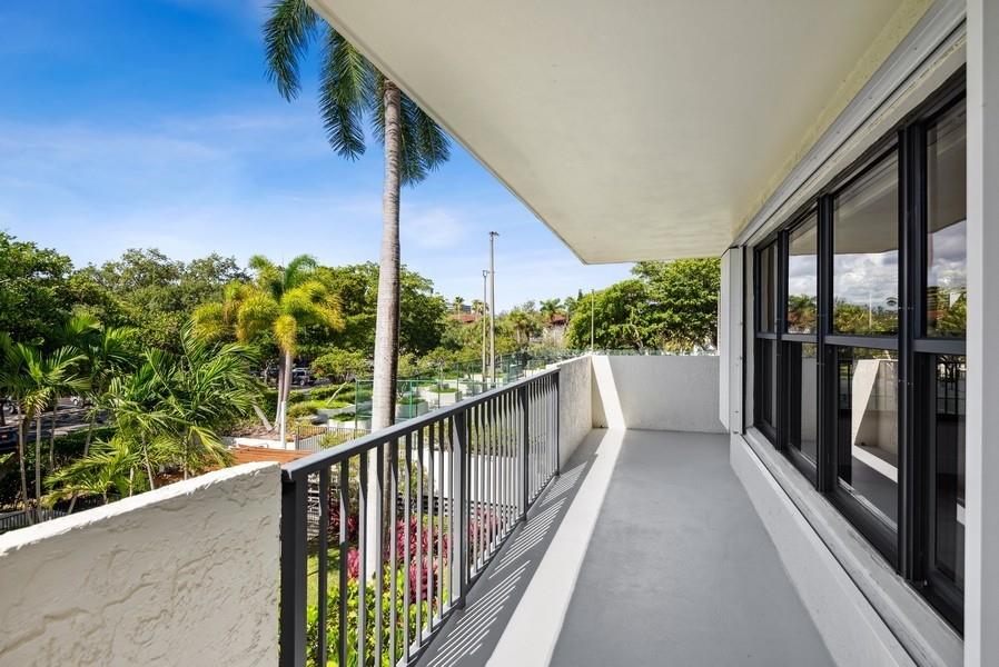 Balcony wraps around to rt. with view of tennis.