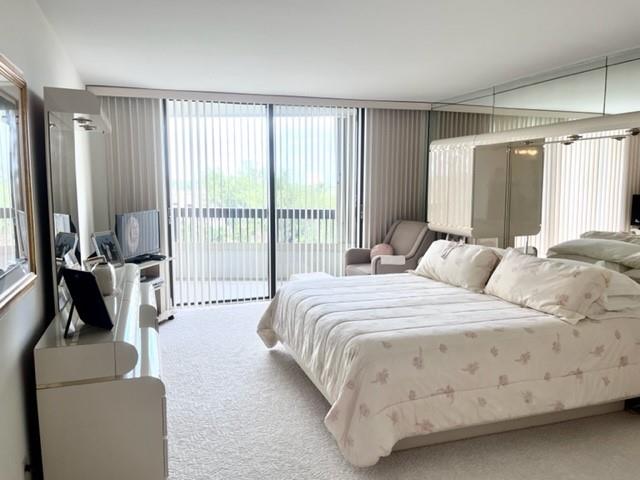 Large bedroom with sliders to oversized covered balcony