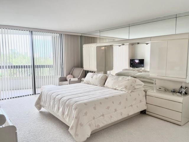 Large bedroom with sliders to oversized covered balcony