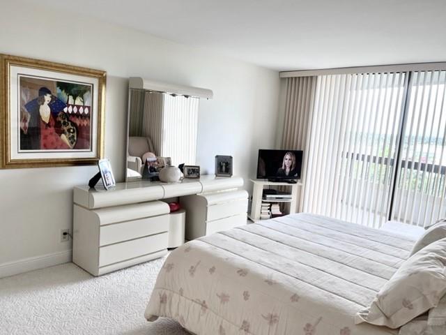 Large bedroom with sliders to oversized covered balcony