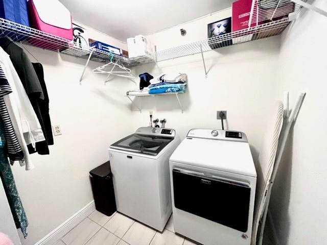 Large laundry room with high end washer and dryer with lots of storage.