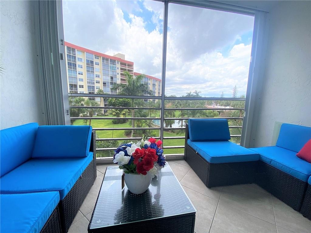 Screened-in balcony with garden view
