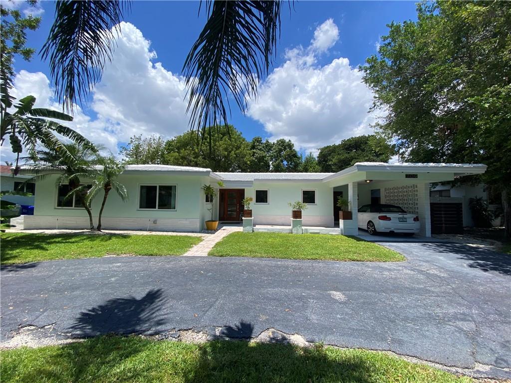 large circular driveway with carport