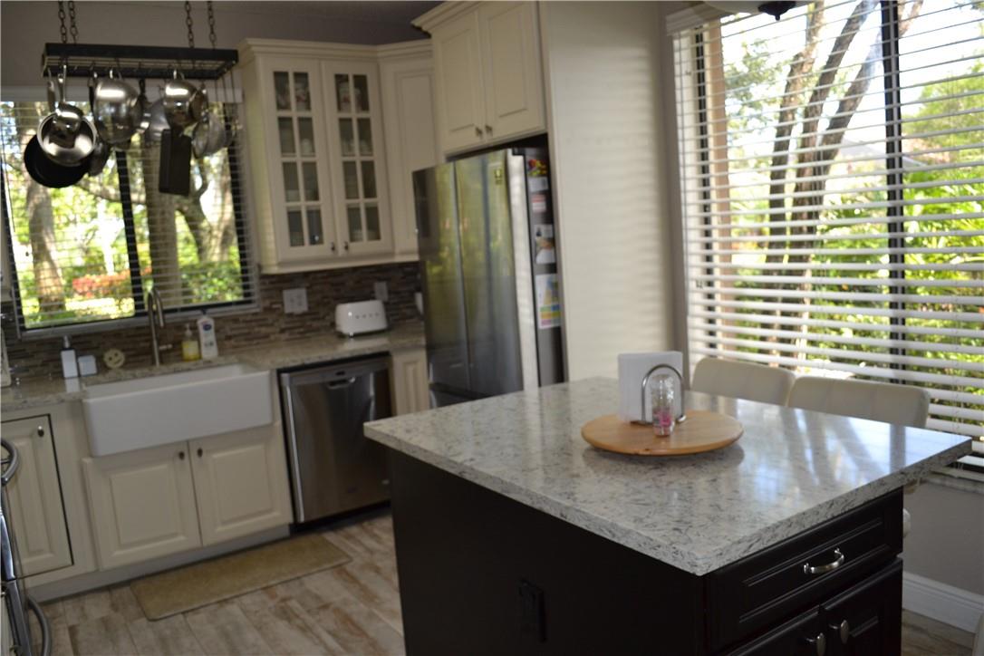 CENTER ISLAND WITH ADDITIONAL STORAGE AND ELECTRICAL  OUTLETS.