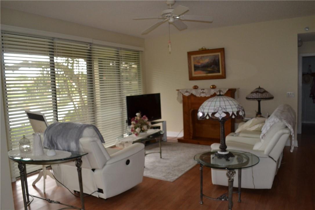 FAMILY ROOM WITH SLIDING GLASS DOORS TO PATIO WITH THE BEAUTIFUL LAKE VIEW.