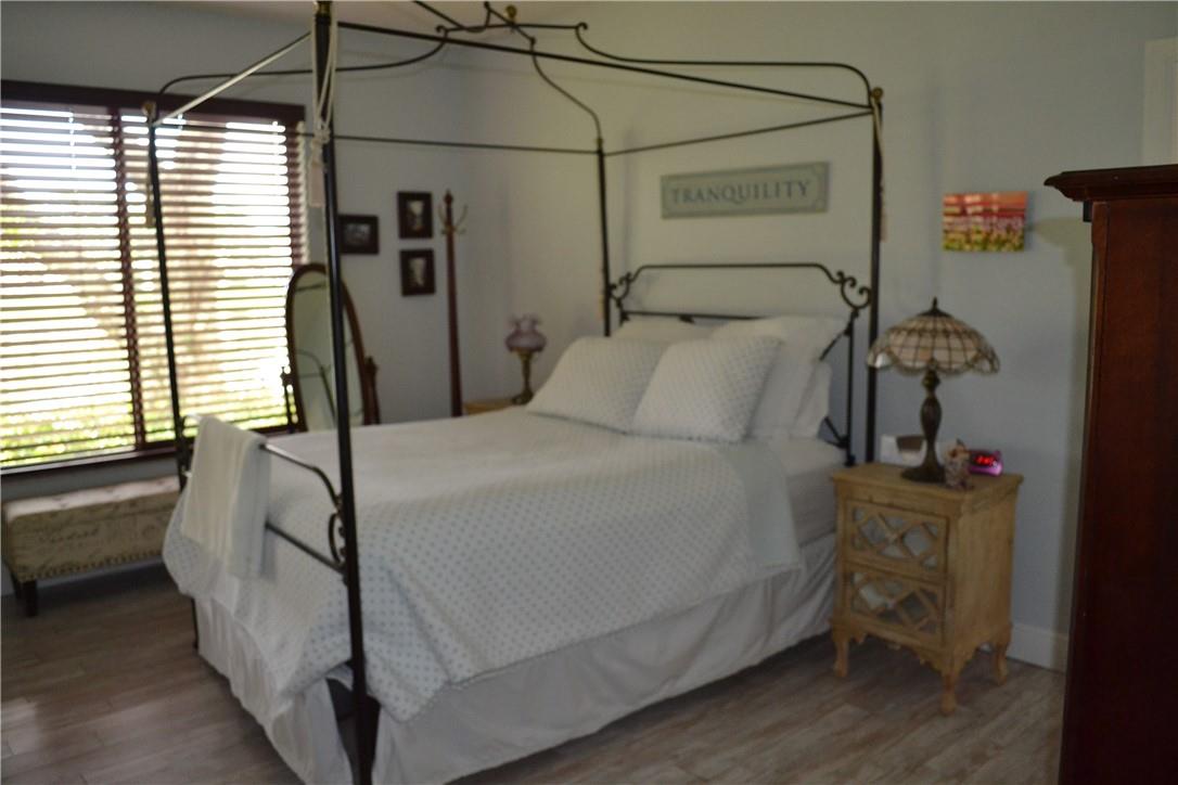 MASTER BEDROOM WITH A WINDOW AND THE BEAUTIFUL LAKE VIEW.