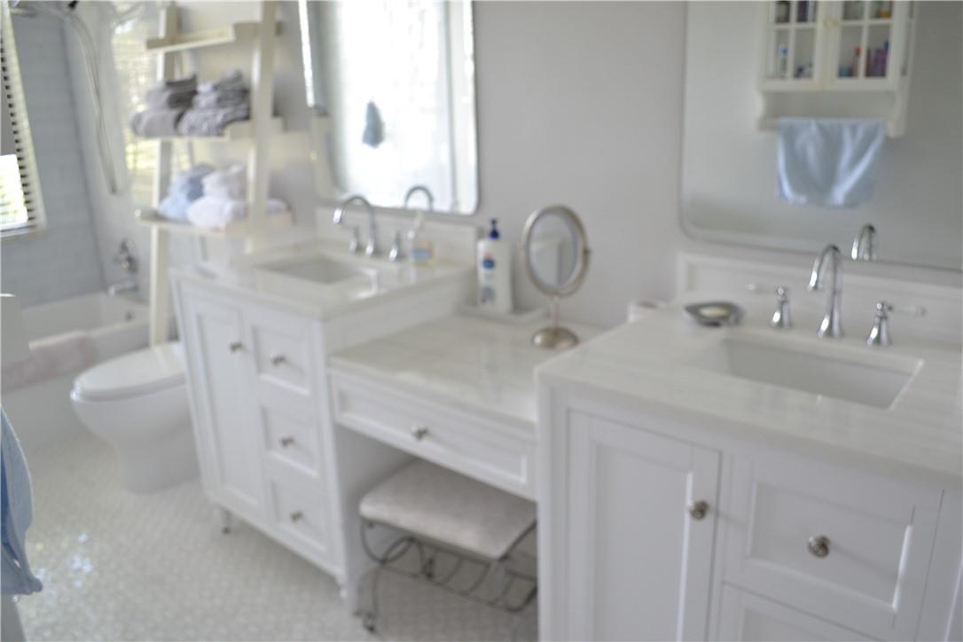 BEAUTIFULLY REMODELED MASTER  BATH WITH DOUBLE SINKS AND MAKE UP AREA.