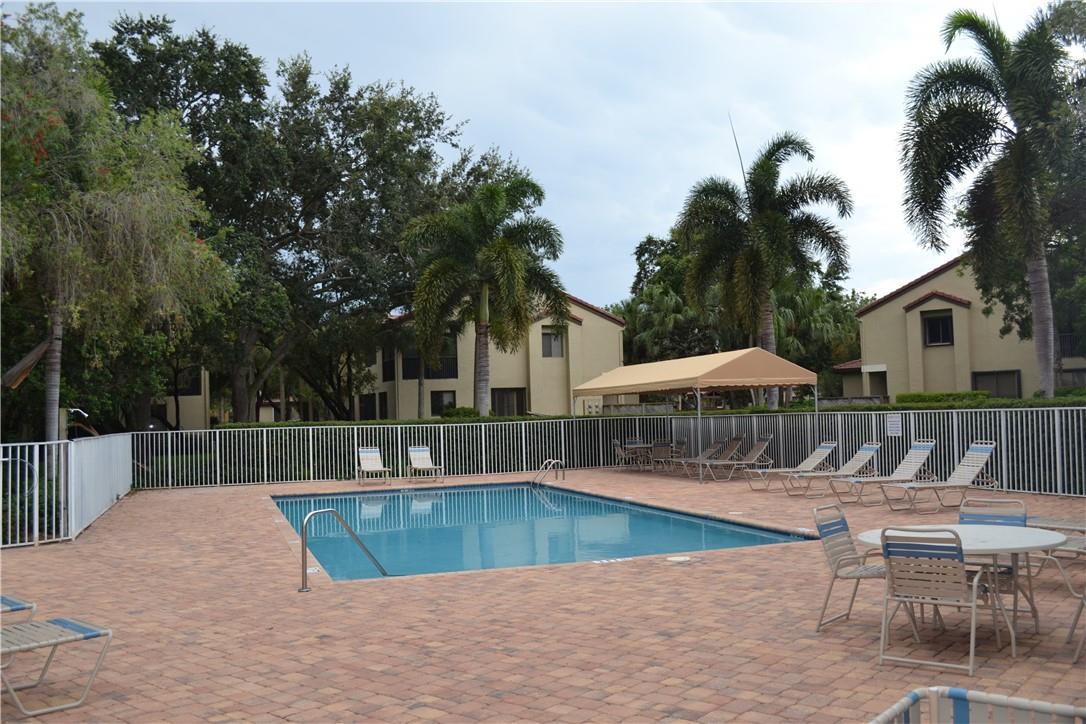 LOUNGE CHAIRS, COVERED SITTING AREA AND TABLES.