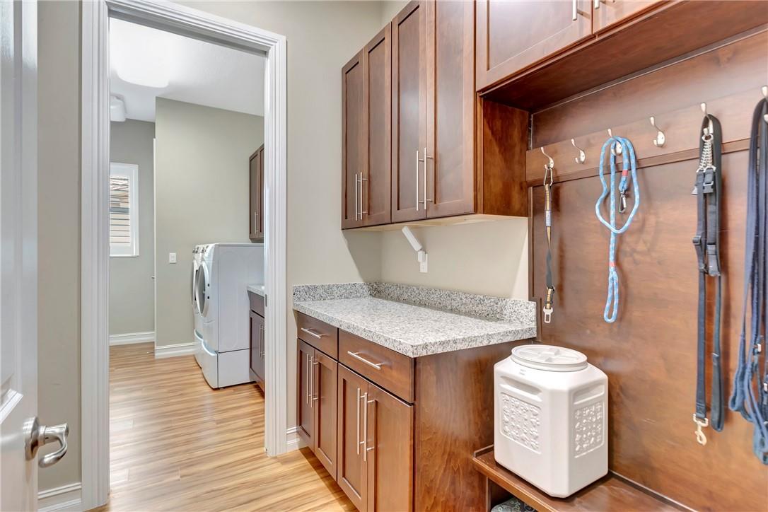 Laundry/Mud Room with additional cabinets & modern style locker.