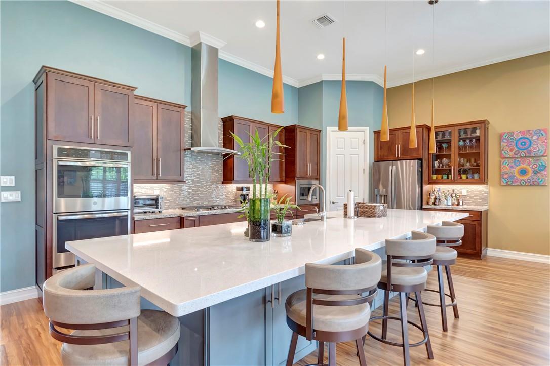 The Kitchen was upgraded to the builders Level 3 Ultra Gourmet Kitchen with custom cabinets/pantry along with top of the line (level 2) appliances.