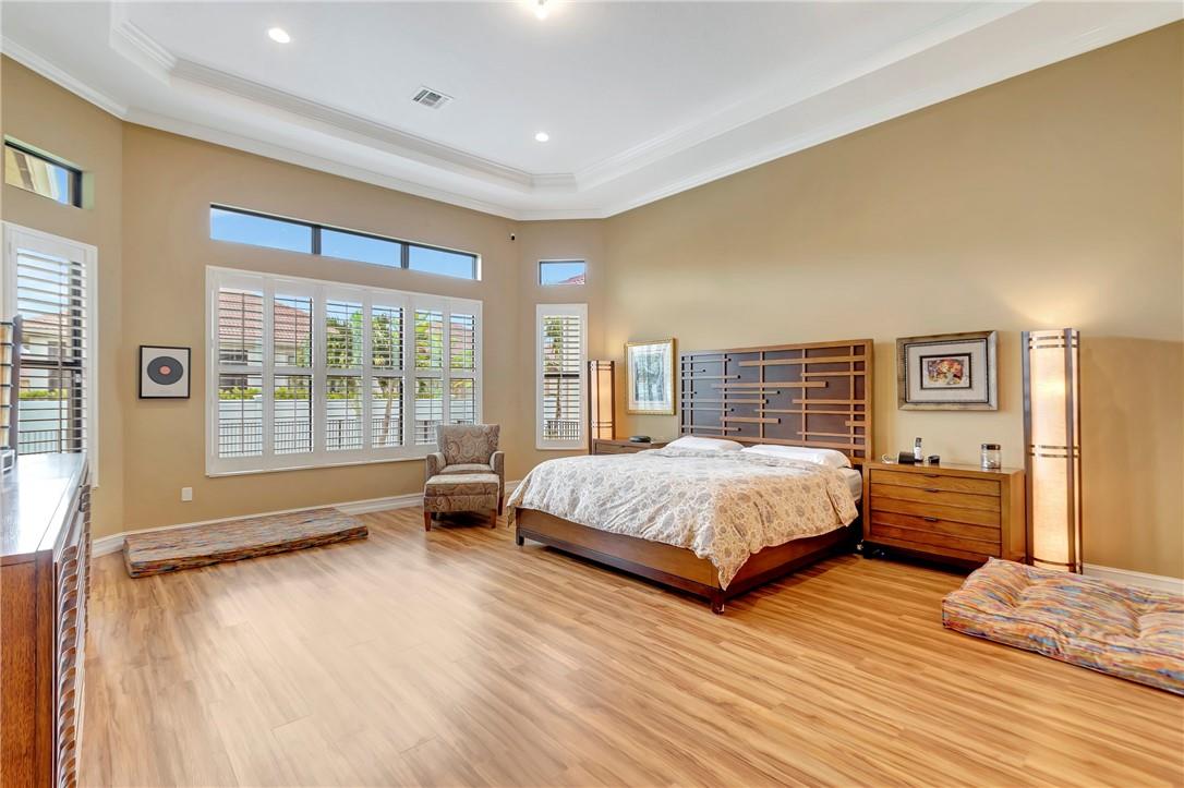 The generous sized Primary Bedroom features the 13 ft high tray ceilings making the space feel even more grand and and has a sitting area, two walk-in-closets and en-suite bathroom.