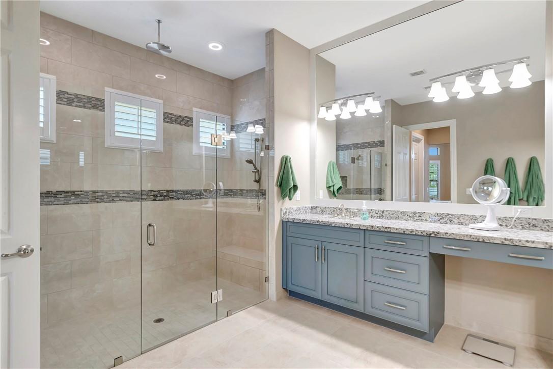 The Primary Bathroom was upgraded to the builders Ultra Spa Owner’s suite which includes: an oversize shower, two shower seat benches, double shower heads, a hand held shower wand and center drop down rain shower head.