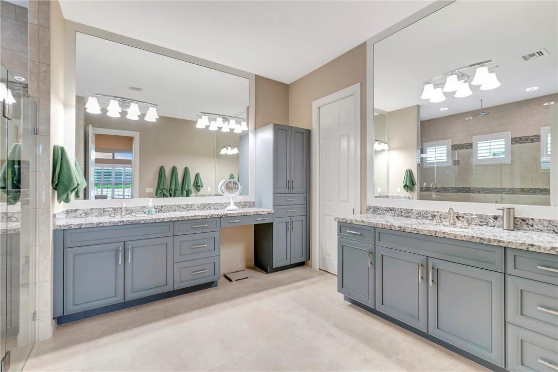 The Primary Bathroom also has double vanities with ample storage and mirrors to the ceiling.