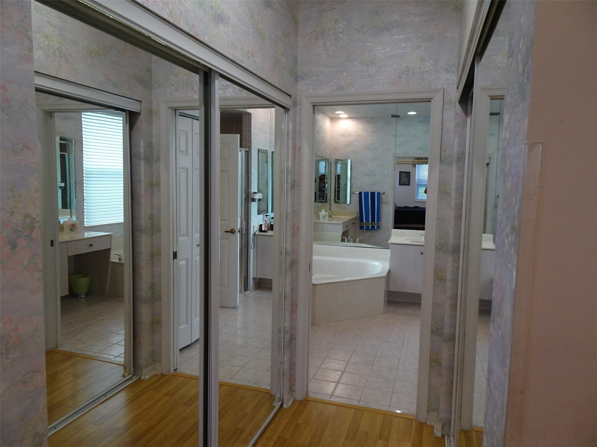 HIS AND HERS MIRRORED CLOSET