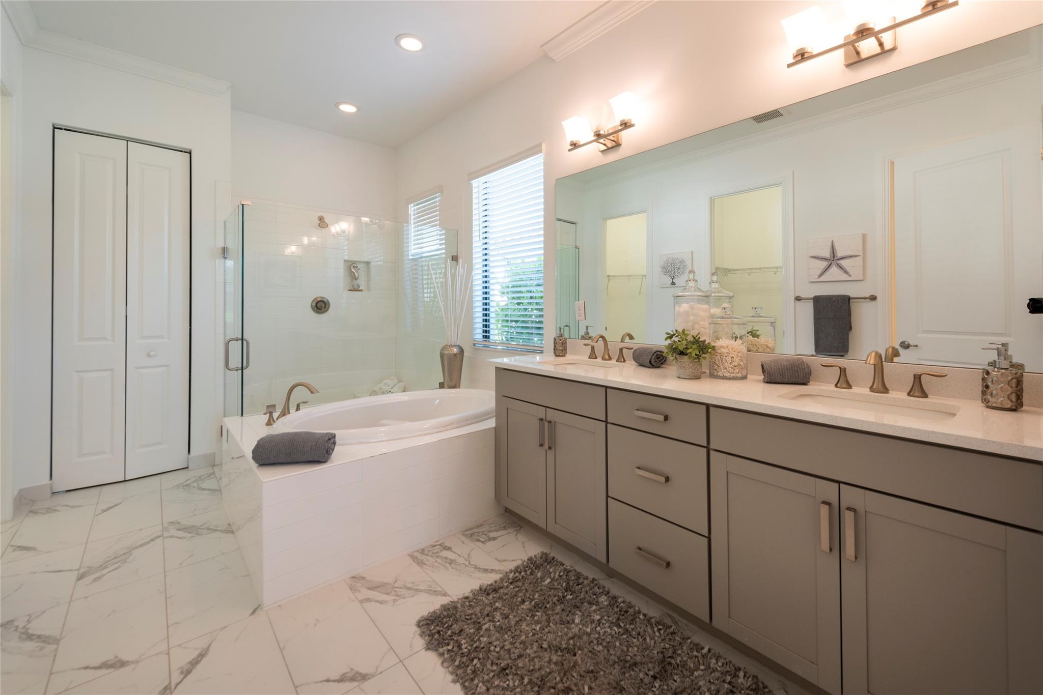 HUGE PRIMARY BATHROOM WITH DUAL SINKS, SEPARATE TUB AND SHOWER, PRIVATE WATER CLOSET, TWO WALK-IN CLOSETS AND A LINEN CLOSET
