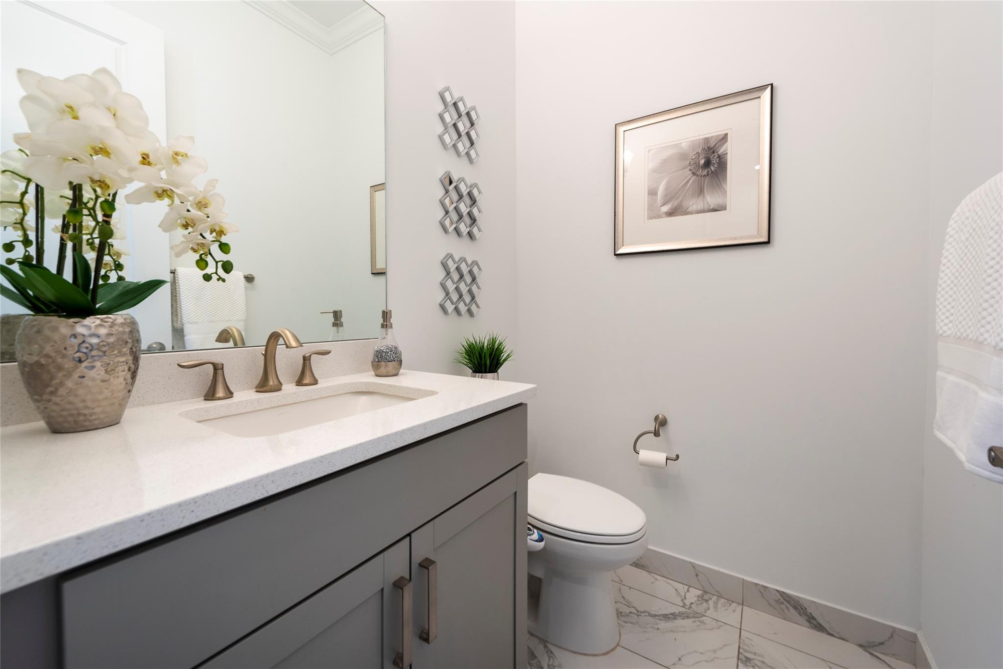 THIS LOVELY FRESHLY PAINTED HALF BATH IS LOCATED ON THE FIRST FLOOR CONVENIENT FOR ADDITIONAL FAMILY AND GUESTS