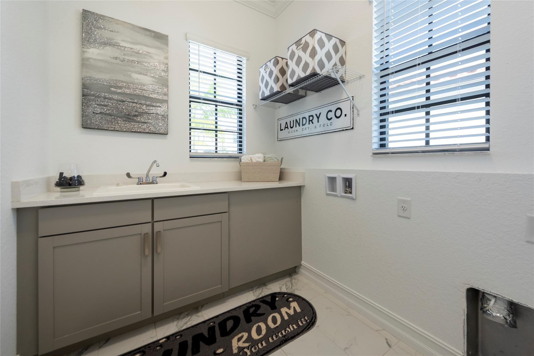 YOUR VERY LARGE LAUNDRY ROOM IS PERFECTLY LOCATED ON THE FIRST FLOOR! THIS LAUNDRY ROOM HAS BEAUTIFUL CABINETRY, A SINK AND ADDITIONAL SPACE FOR FOLDING CLOTHES. THE TWO WINDOWS KEEP THIS ROOM BRIGHT AND CHEERFUL!