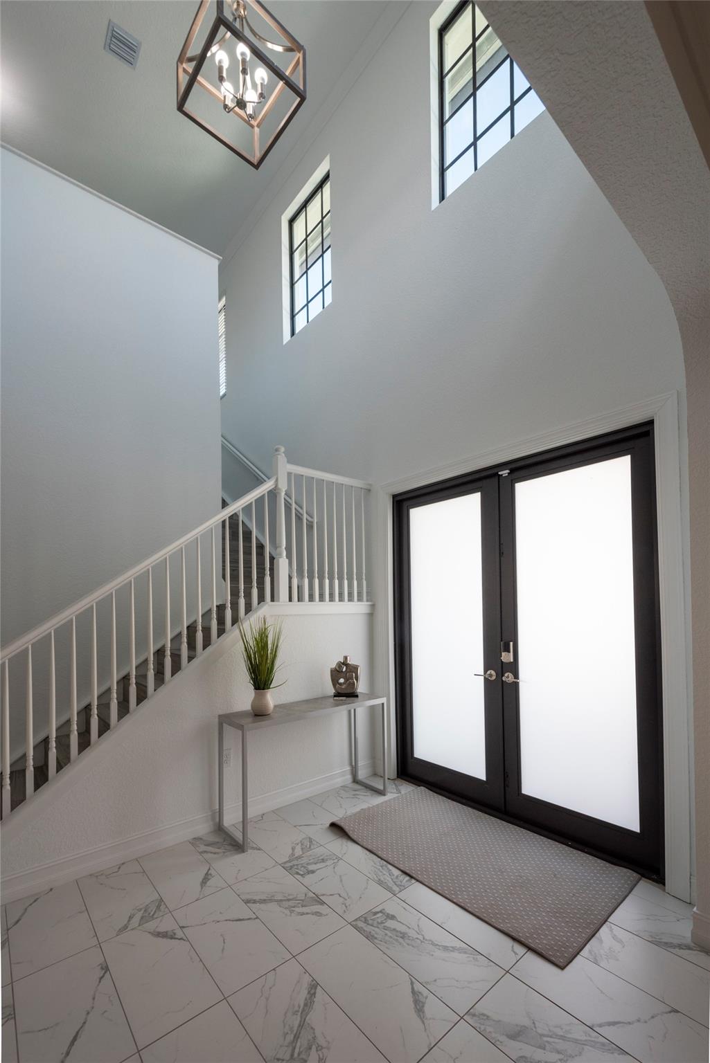 THIS GORGEOUS ENTRY AWAITING YOUR ARRIVAL, BOASTS 2 STORY OPEN AND BRIGHT SPACE WITH STAIRS LEADING TO YOUR SECOND FLOOR !