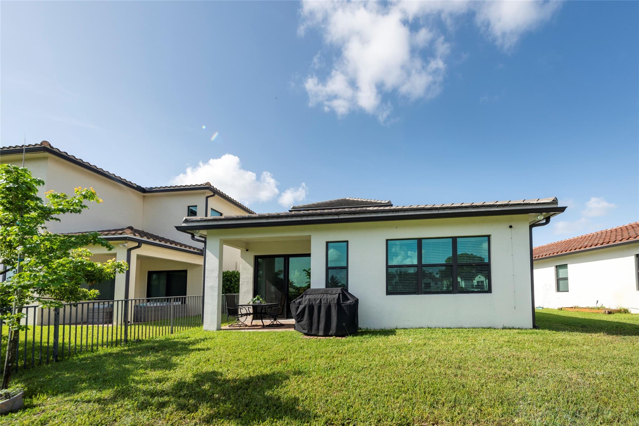 SUCH A BEAUTIFUL BACK YARD WITH A COVERED PAITO AREA AND ROOM FOR FAMILY GATHERINGS OR A POOL!