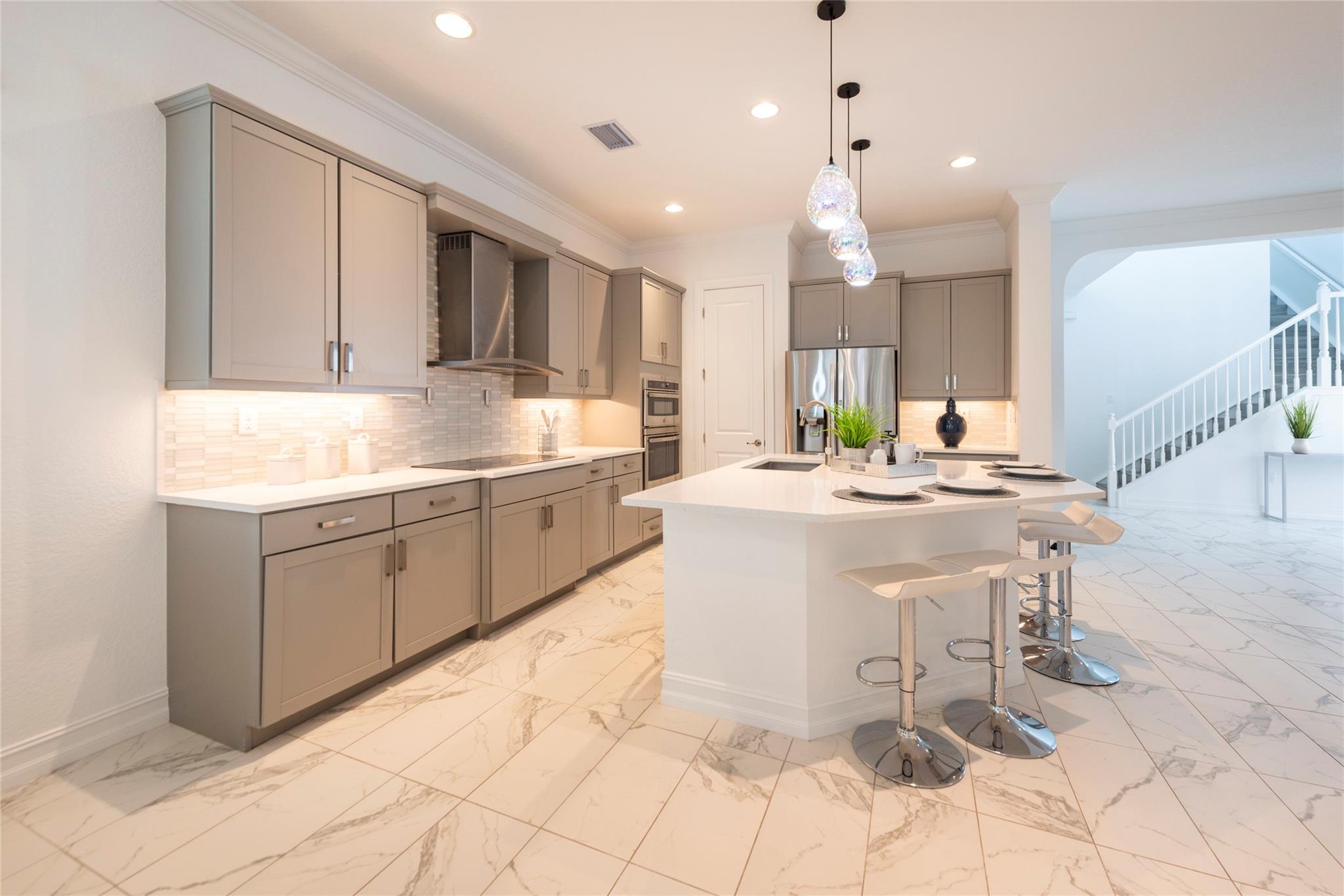 GORGEOUS LARGE KITCHEN WITH BEAUTIFUL LIGHT FIXTURES OVER THE ISLAND, A HUGE WALK-IN PANTRY, MODERN CABINETRY WITH UNDERMONT LIGHTING OPEN TO LIVING AND DINING ROOMS FOR YOUR FAMILY AND FRIENDS GATHERING!
