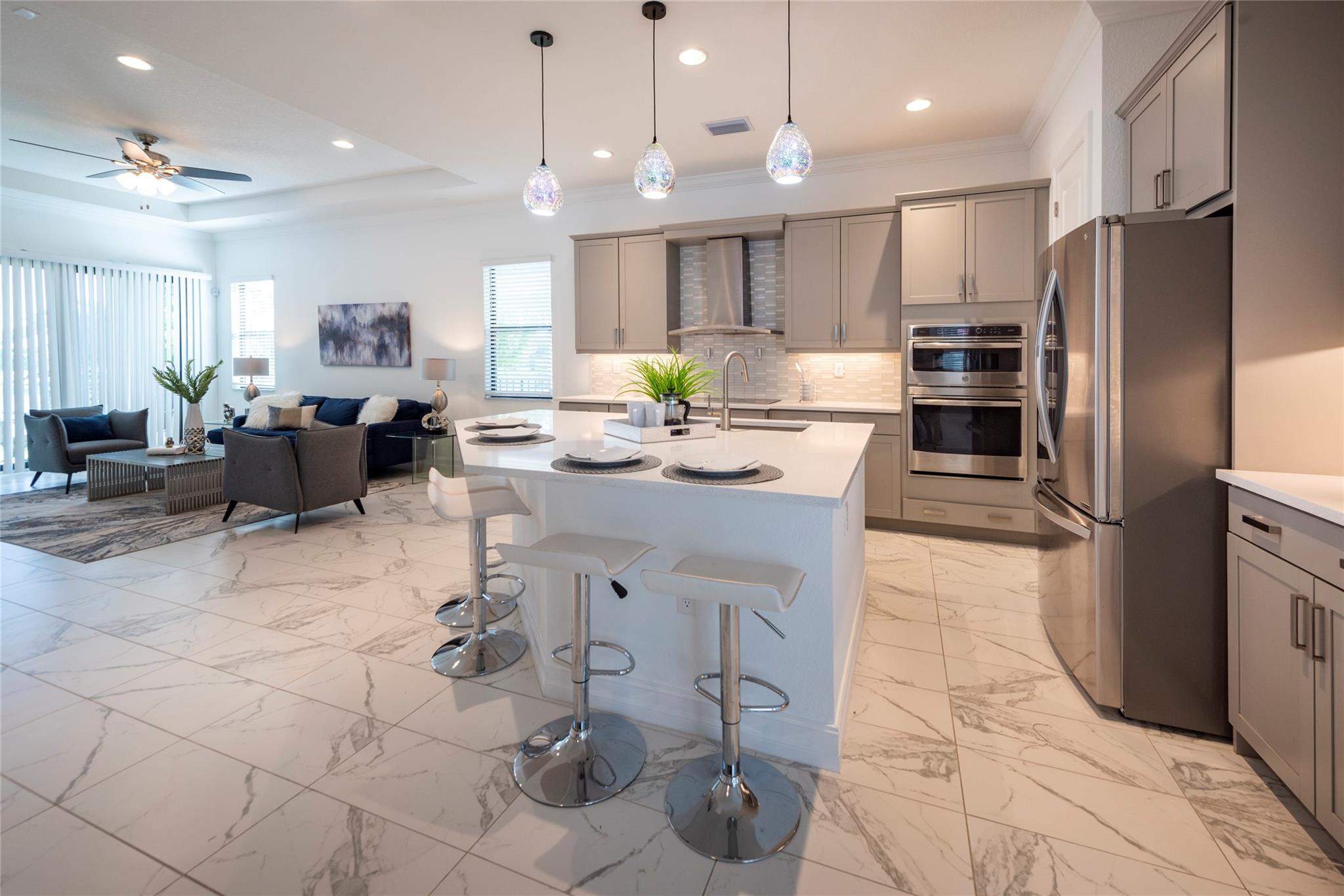 THIS LOVELY AND SPACIOUS KITCHEN WITH SPARKLING QUARTZ COUNTERTOPS IS OPEN TO THE FAMILY ROOM AS WELL AS THE DINING ROOM!  AN ENTERTAINER'S DREAM SPACE!