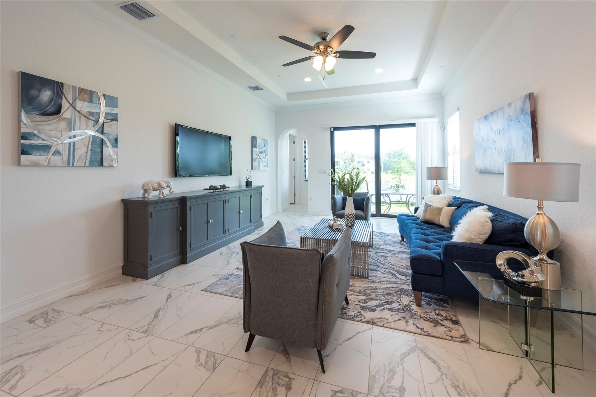 CONTEMPORARY, MODERN, COMFORTABLE AND SPACIOUS FAMILY ROOM OPENS TO THE PATIO AND A GORGEOUS LAKE VIEW FOR EVERYONE TO ENJOY!
