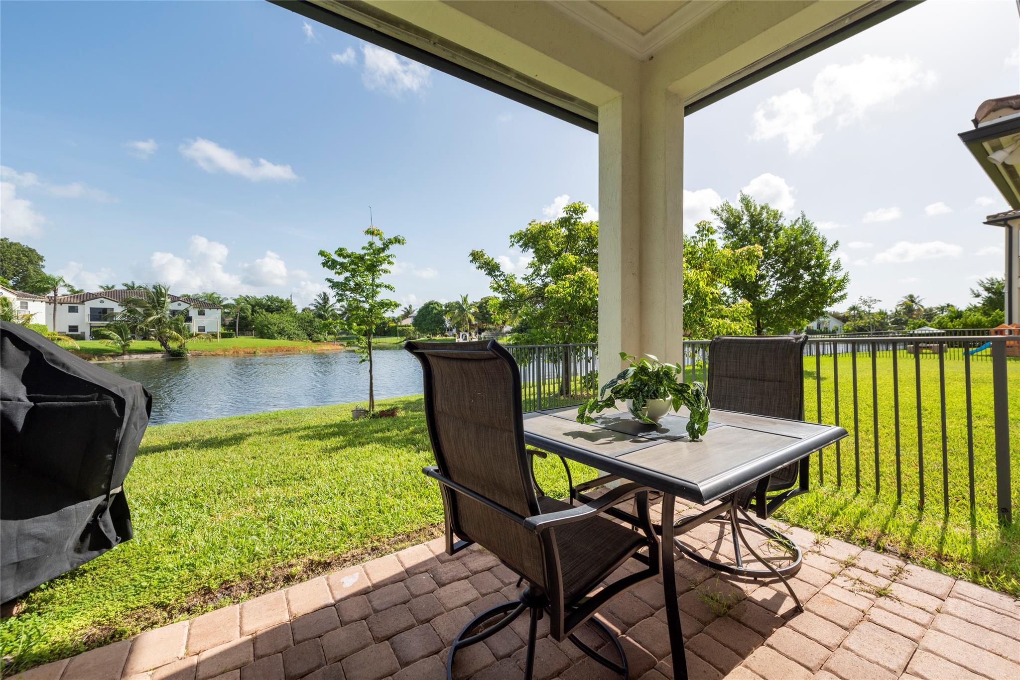 ENJOY YOUR MORNING COFFEE AS YOU STEP THROUGH THE IMPACT DOORS TO YOUR WONDERFUL PATIO WITH THE PEACEFUL LAKE VIEW!