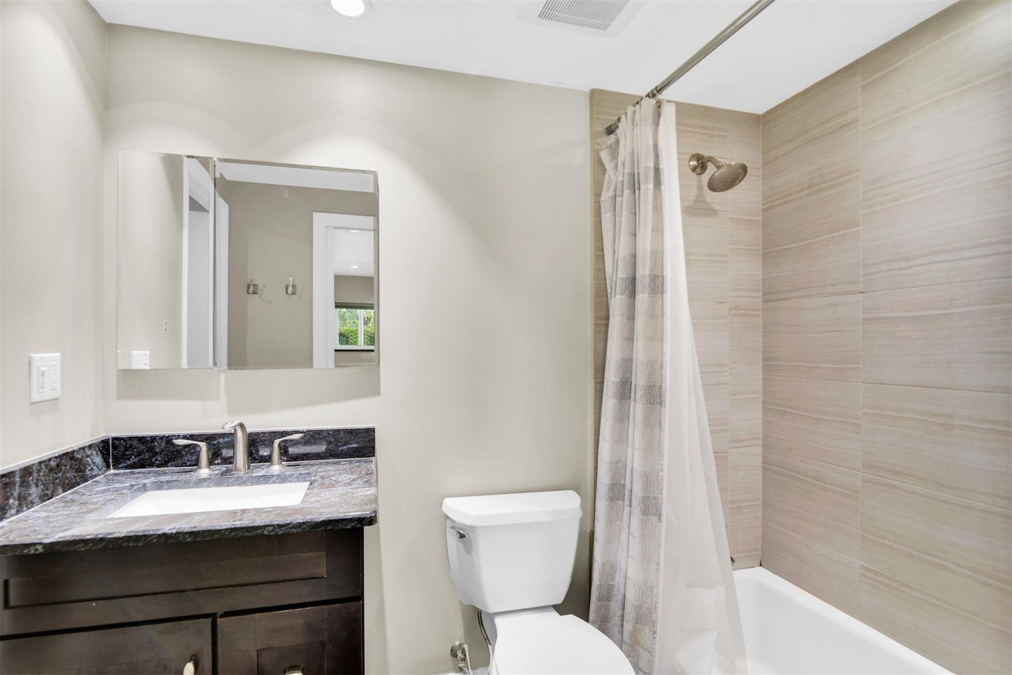 Master bath has blue granite counter tops to match laundry and desk