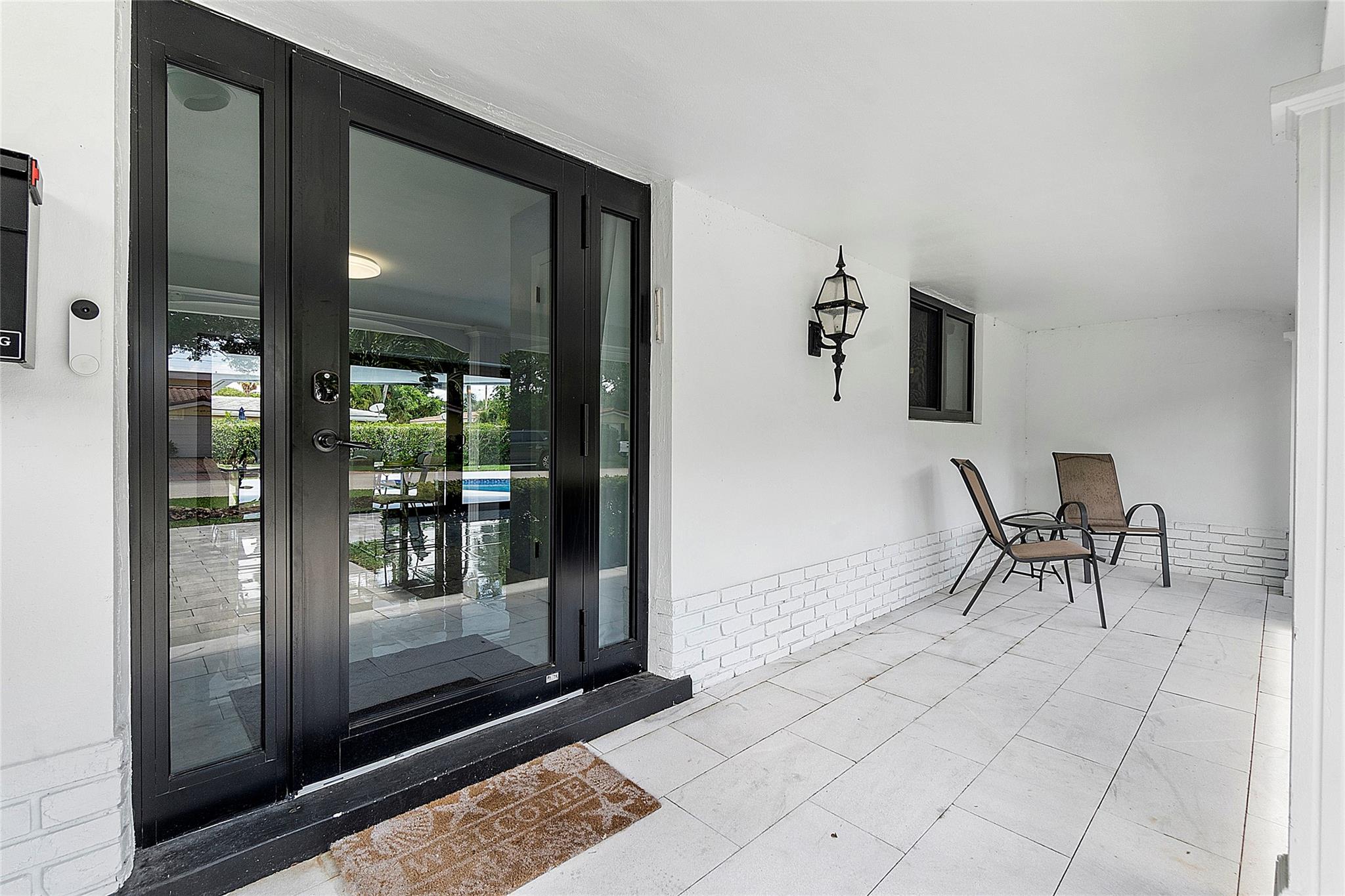 New modern high impact front door lets lot of natural light into the home.