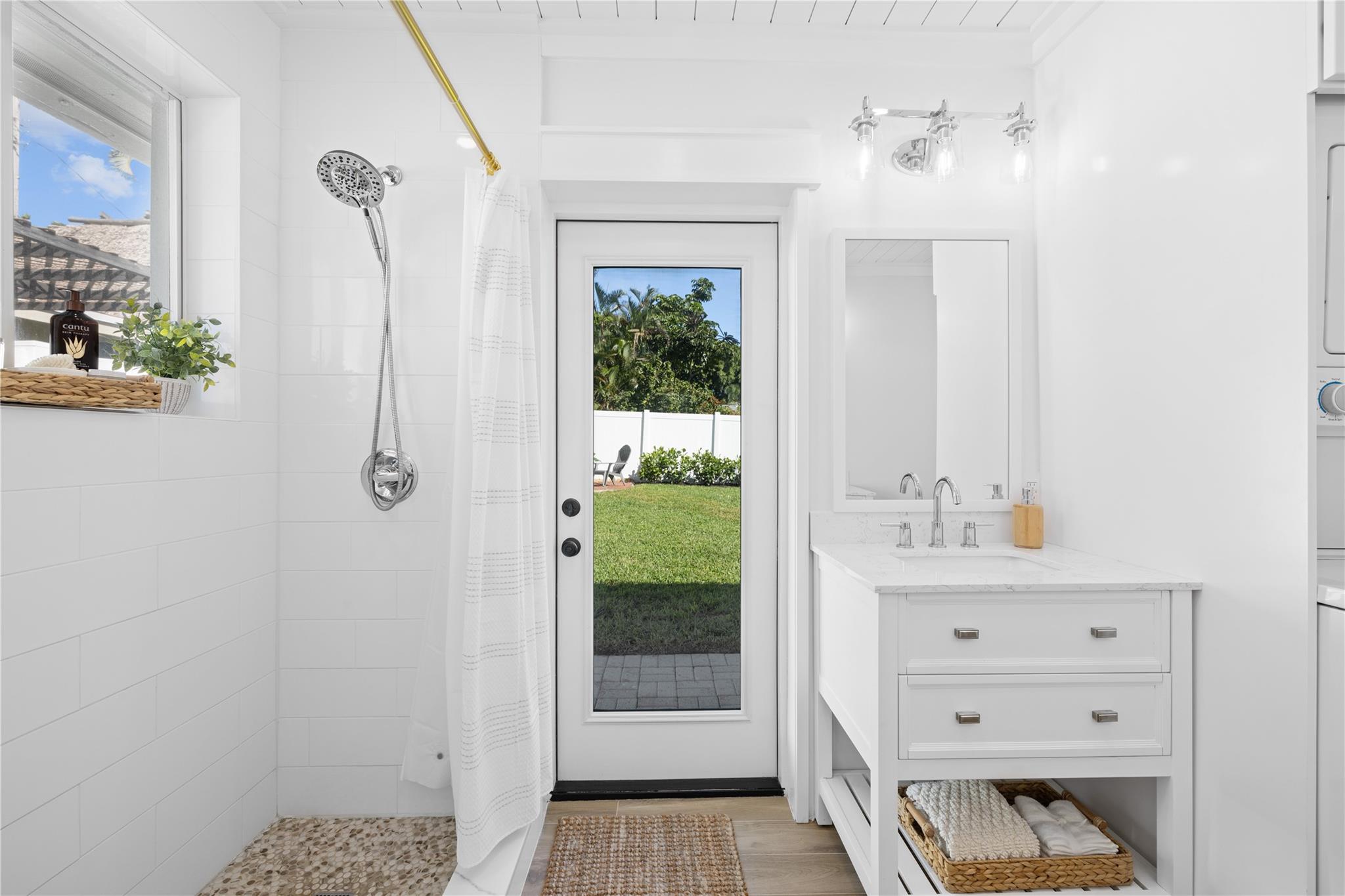 Primary ensuite bath is complete with mosiac-tiled shower and plenty of natural light!