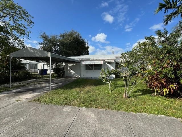 front of house showing driveway canopy and garage