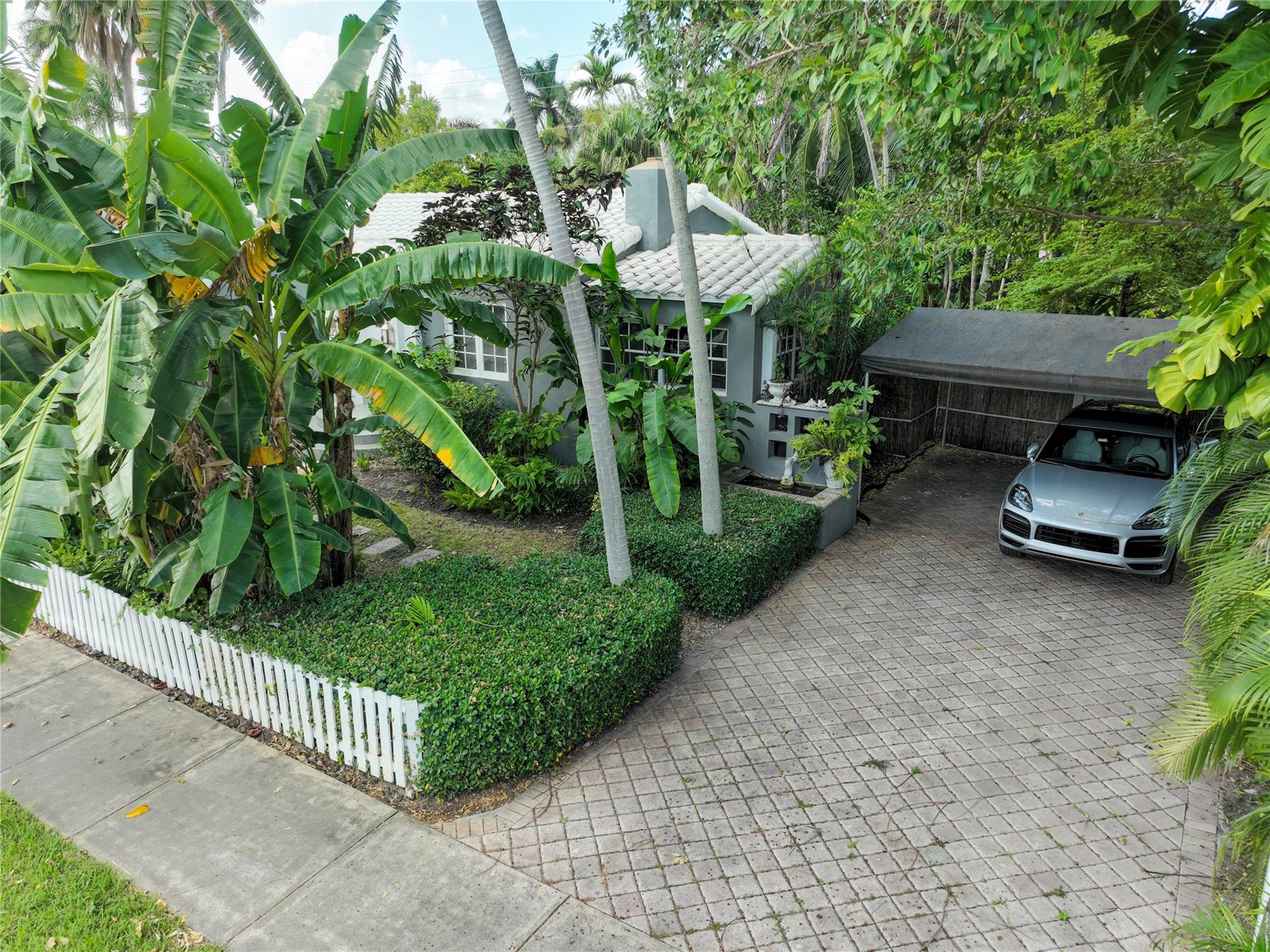 Oversized driveway with two cars carport