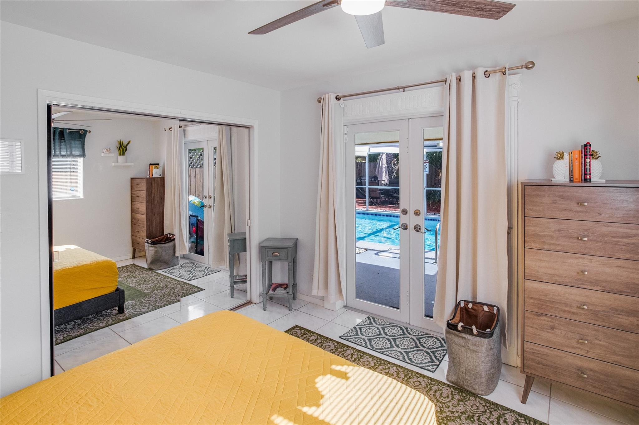 Guest room with pool area access through impact French Doors