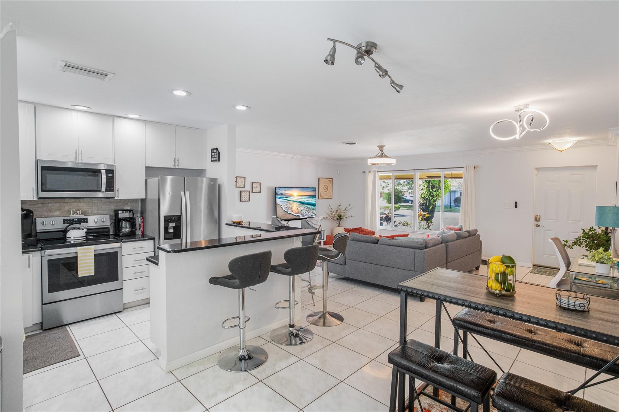 Kitchen with bar and counter seating.