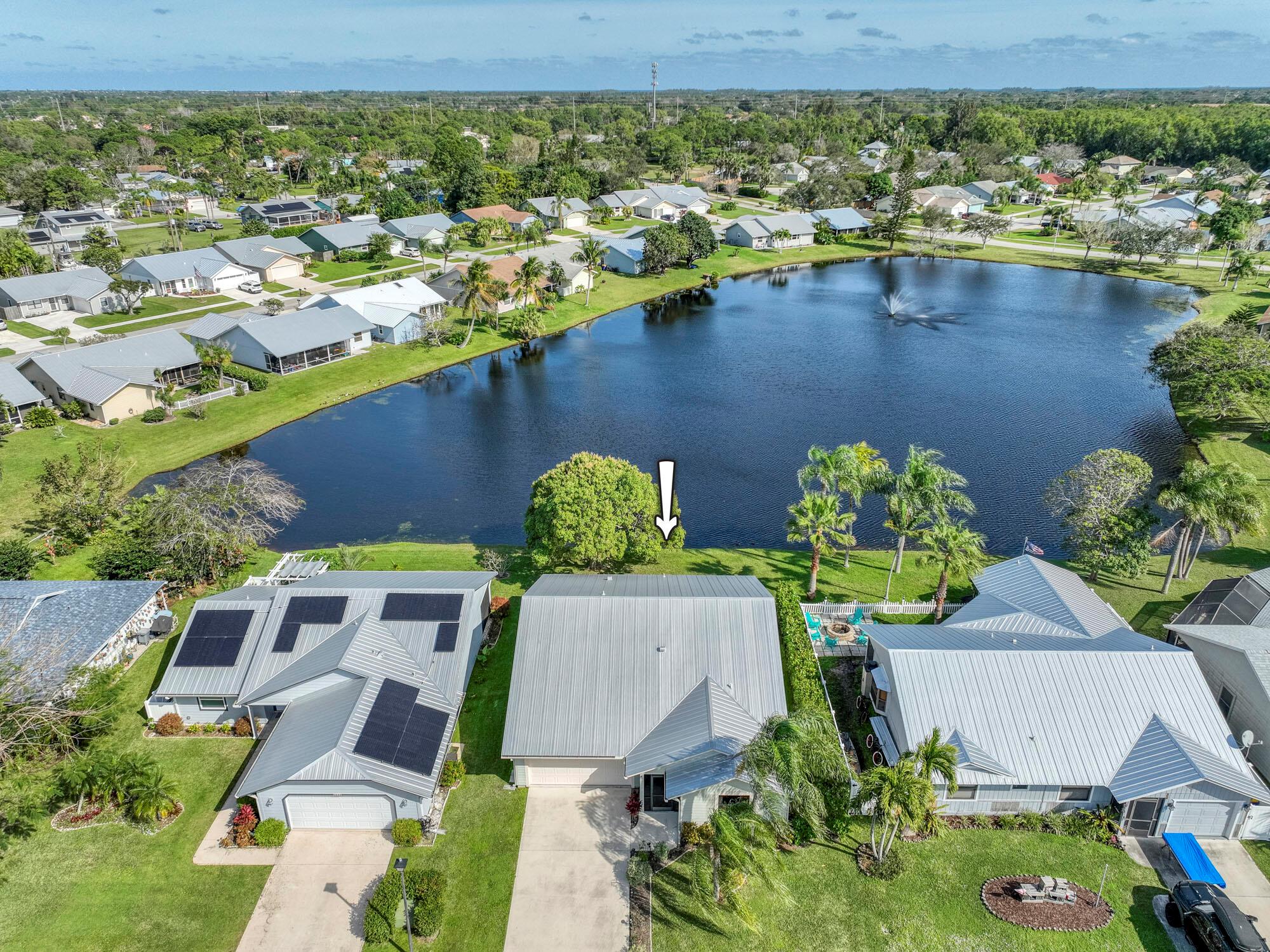 Impeccably maintained, picturesque lakefront 3BR/ 2 Bath home in the charming neighborhood of Parkwood. This highly sought after 3/2 split bedroom floor plan, natural wood-like flooring and spectacular lake views. Kitchen is complemented by S/S appliances, granite counters, center island, vaulted ceilings and the open floor plan makes this home ideal for entertaining. Primary bedroom boasts a walk-in closet, additional storage and bath with double vanities and walk-in shower.  Enjoy peace of mind with newer AC (2021), Metal roof (2015) impact windows, newer Electric Panel (2022), public sewer and water, large driveway, 2 car garage, and very low monthly HOA. Parkwood is also a pet friendly community (up to 4 pets).