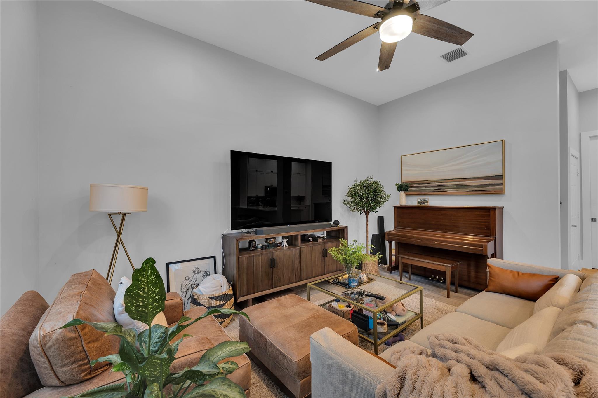 Living room with recessed lights and overhead fan