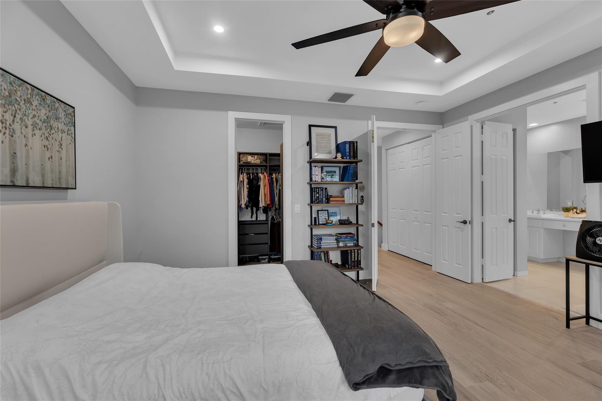 Master Bedroom with trey ceilings and recessed lighting
