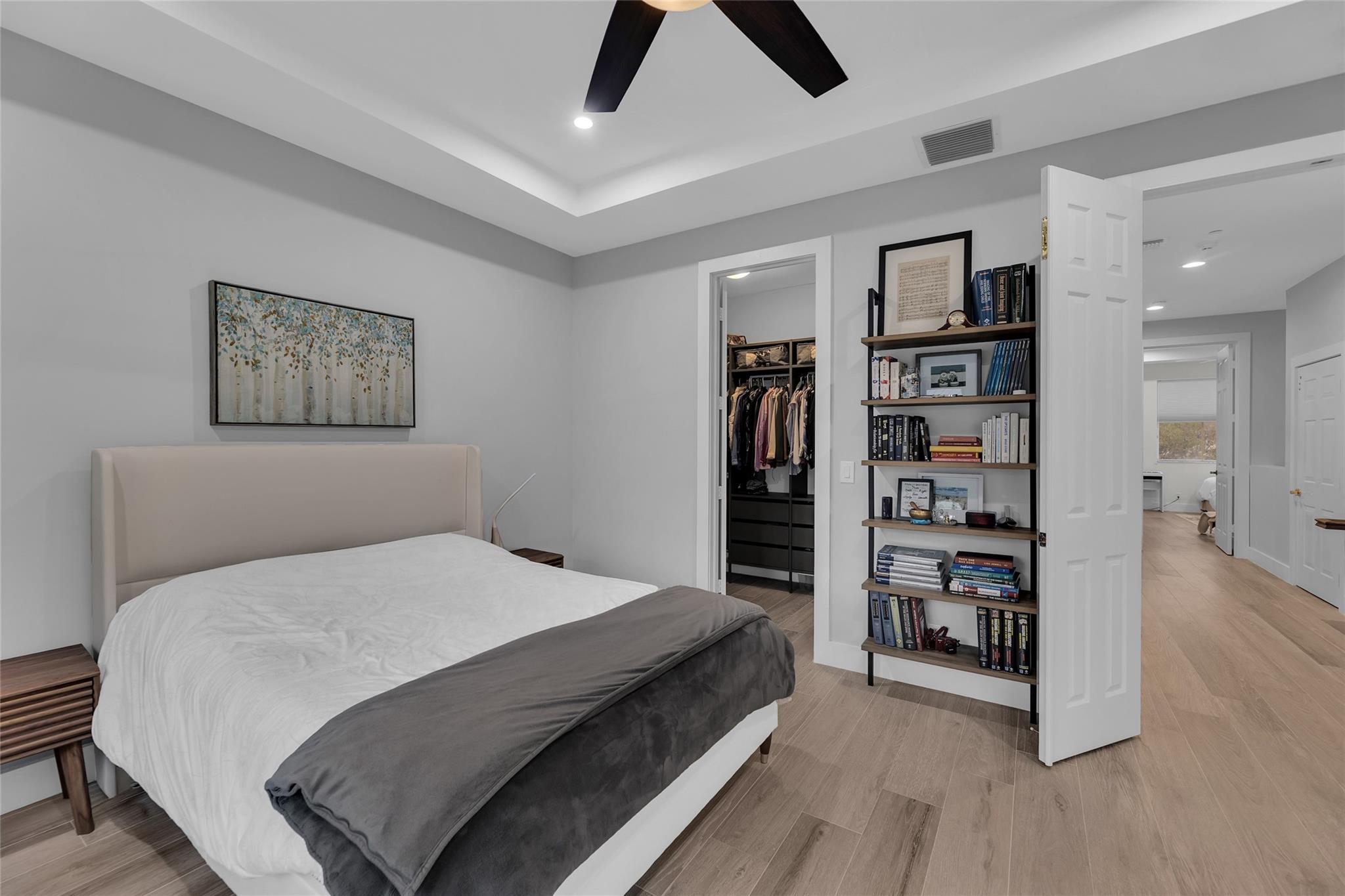 Master with walk in closet with custom gray built ins