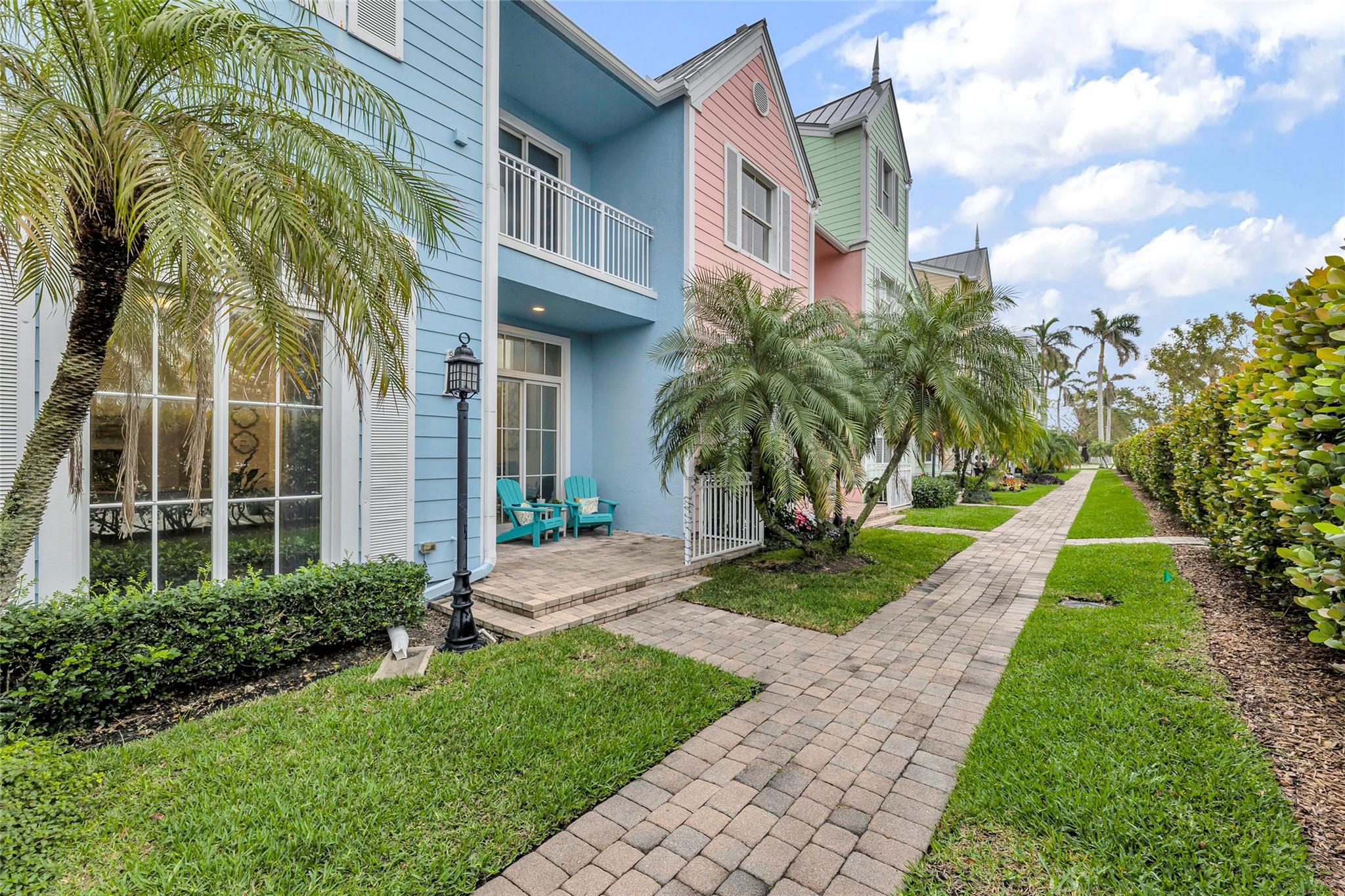 Pavered walk ways throughout community with meticulous tropical landscaping
