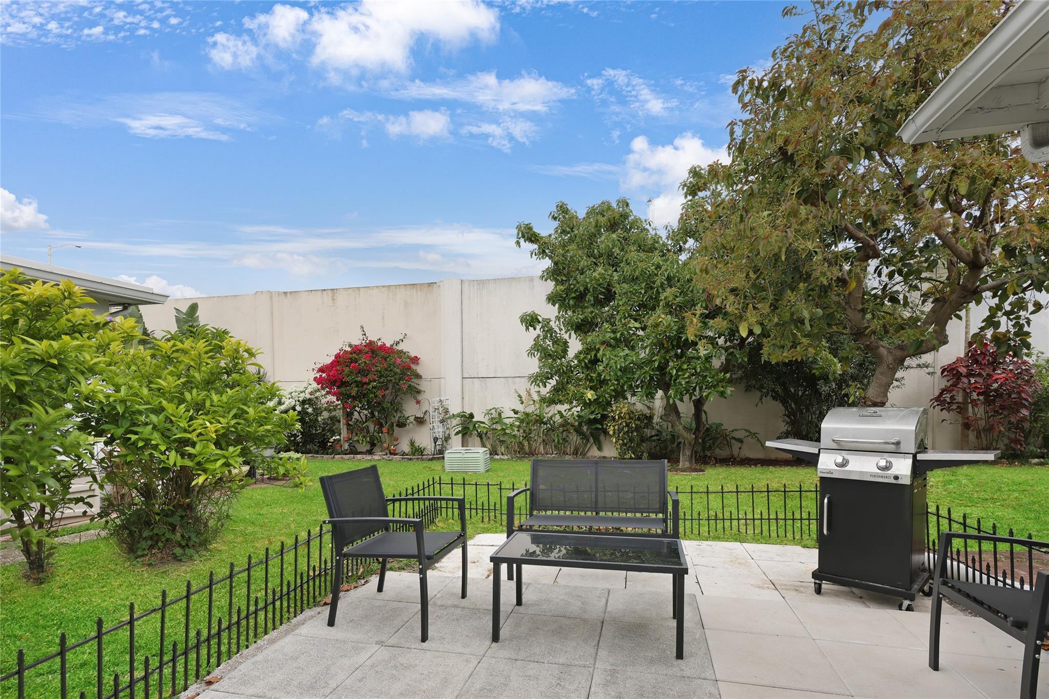 This private back yard offers a place to BBQ and Avocado trees.